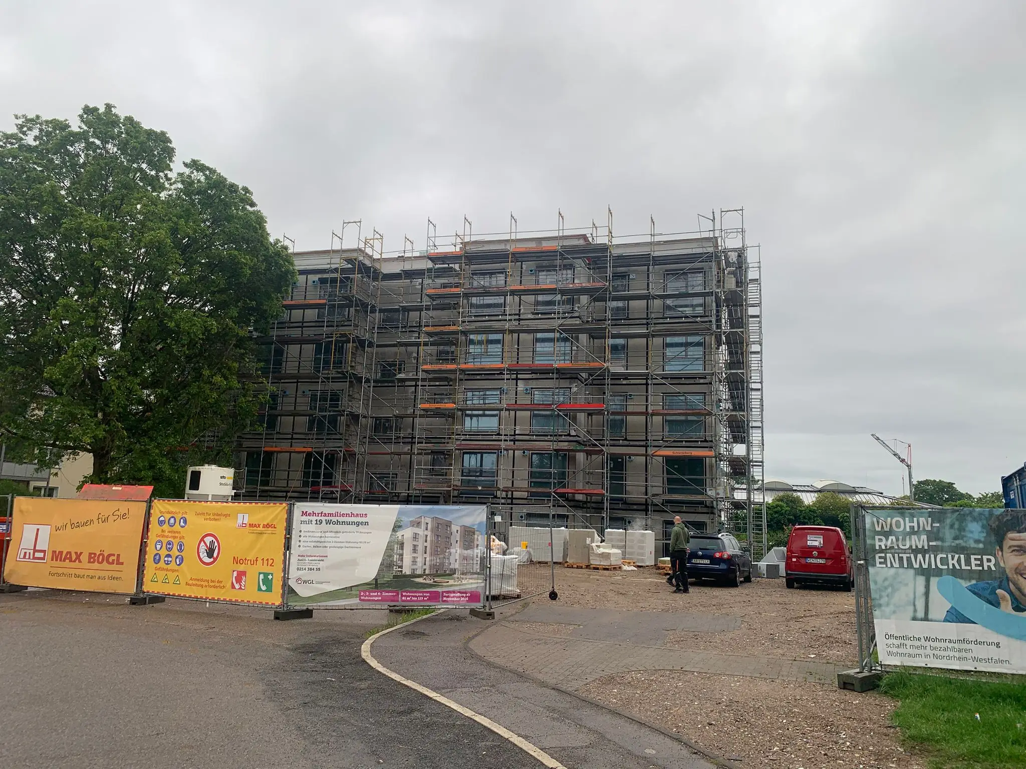 Apartment building under construction behind scaffolding