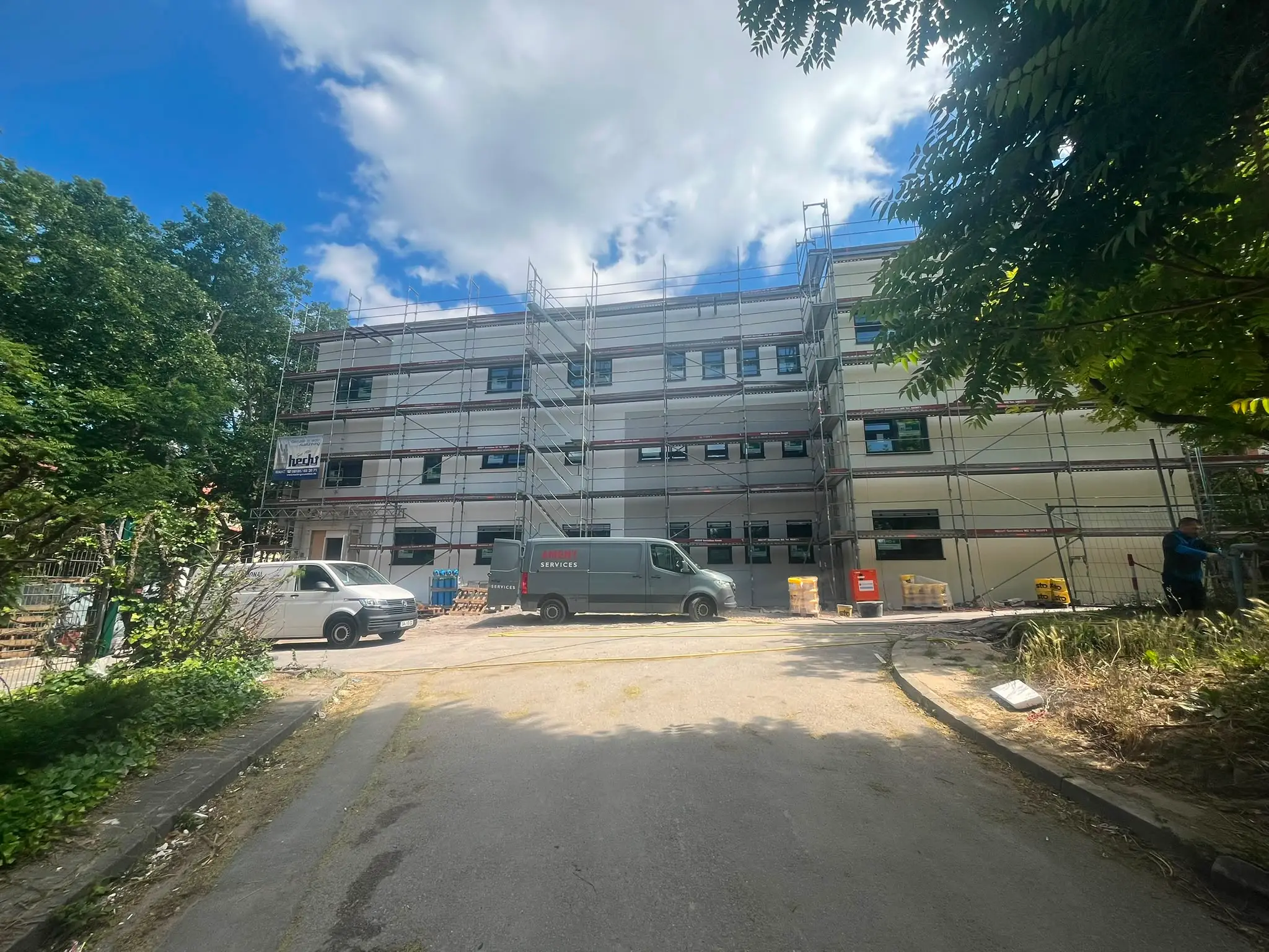 Clinic building under construction behind scaffolding