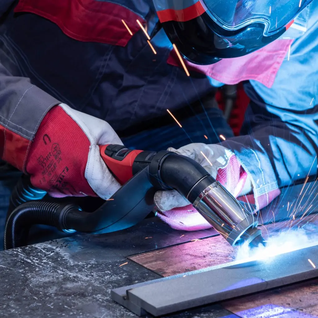 Froler welder at work on a construction site, sparks flying